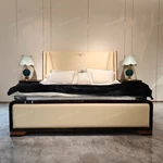Cream Leather Upholstered Bed with Dark Natural Wood Veneer Trim, Embossed Brand Emblem & Copper-Accented Hardware